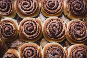 Cinnamon rolls on a tray after baking. Top view