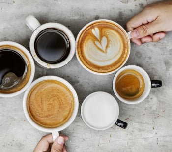 mugs with various coffee drinks in them, placed in a circle