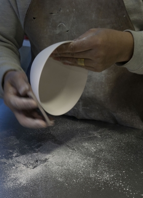 Ment artist polishing a ceramic bowl
