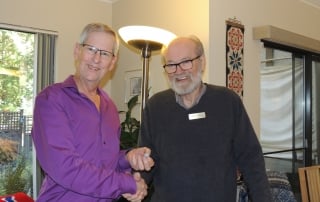 Ron Stubbings receives a pin from Erik Brochmann for his contribution to the Sons of Norway Foundation in Canada