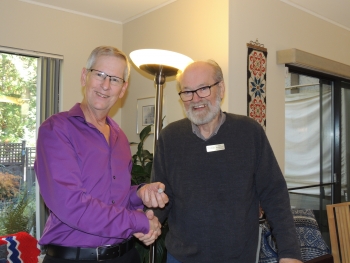 Ron Stubbings receives a pin from Erik Brochmann for his contribution to the Sons of Norway Foundation in Canada