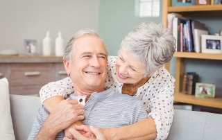 Happy couple embracing at home