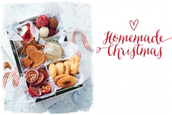 a box with various christmas cookies, next to copy, "Homemade Traditions"