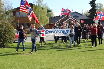 parade with Norwegian and American flags