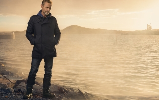 photo of Jo Nesbo standing in front of the sea in Norway