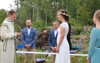 bride and groom standing at the border between Norway and Sweden