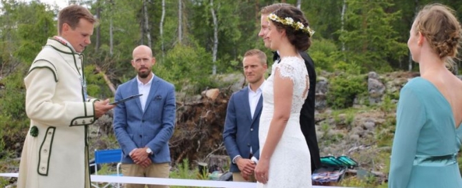 bride and groom standing at the border between Norway and Sweden