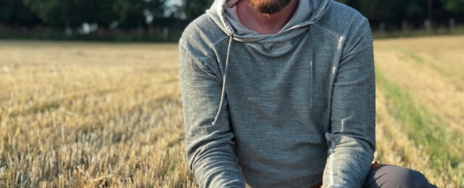 man holding a sword in a field