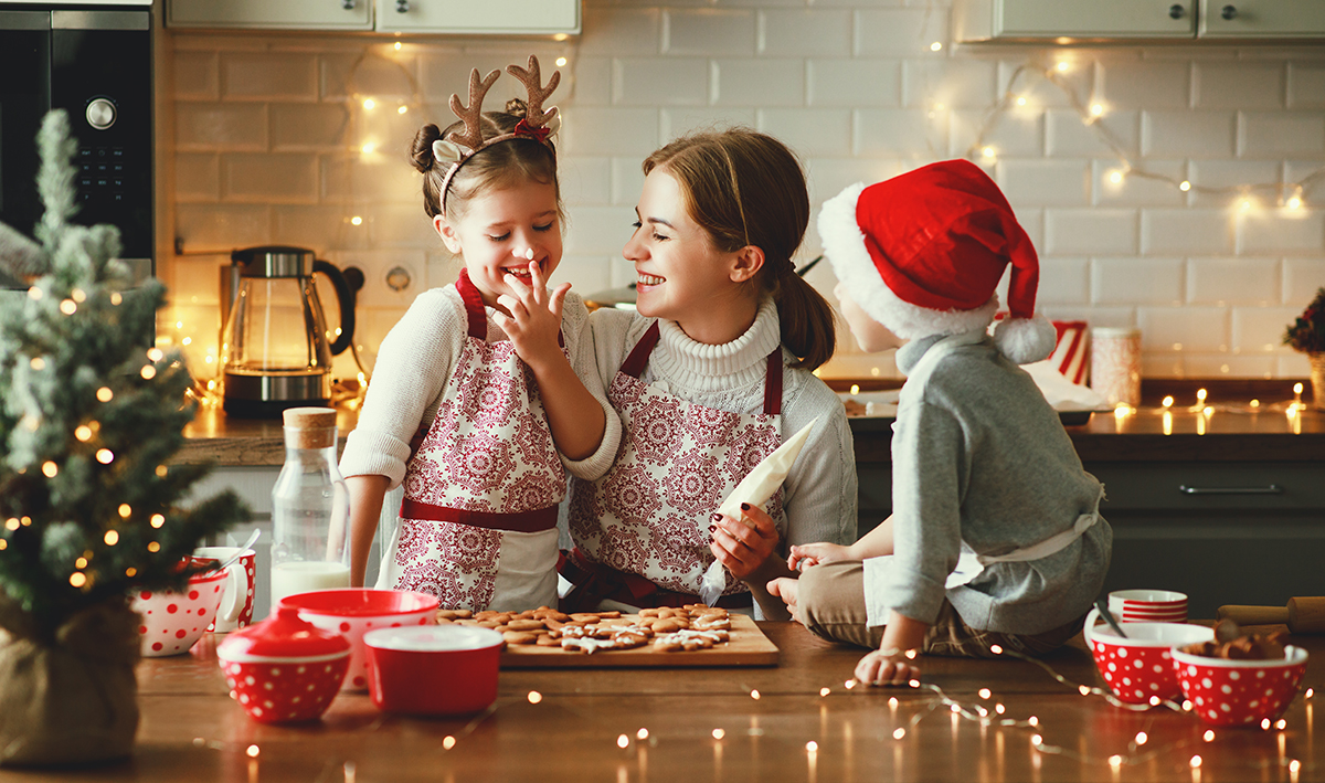 mother and children bake christmas cookies